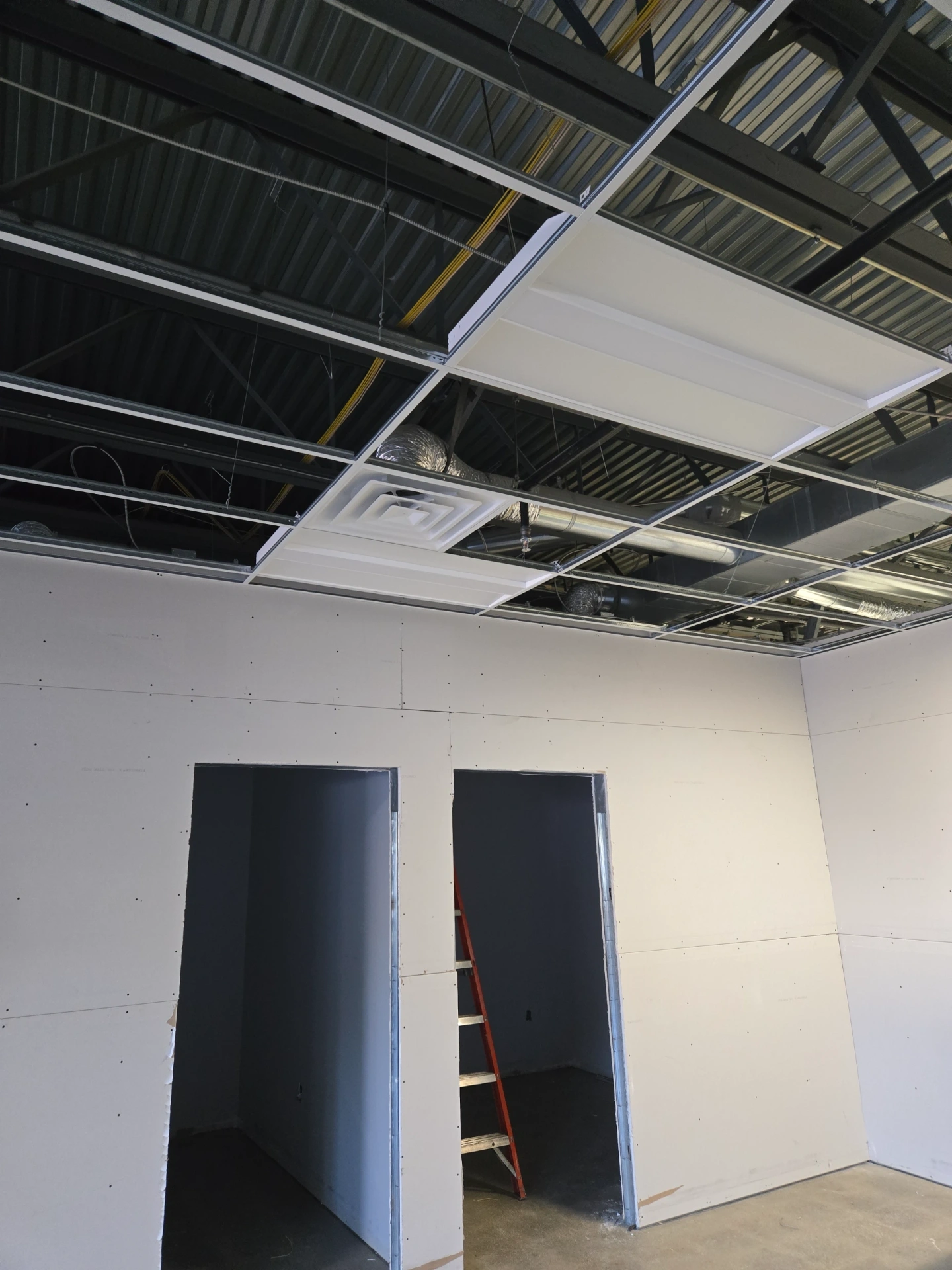 Ducting and drywall during new construction HVAC installation in Howell, MI