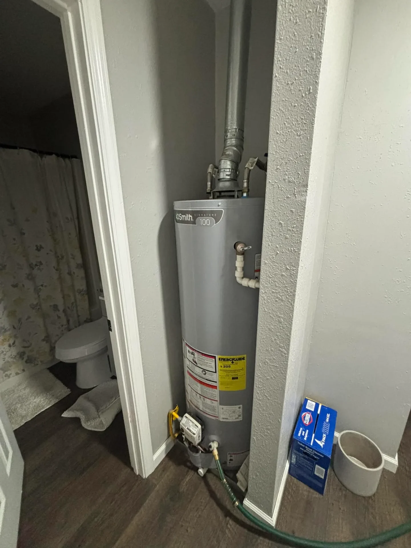 AO Smith water heater in a utility closet installed by Great Lakes Comfort in Howell, MI